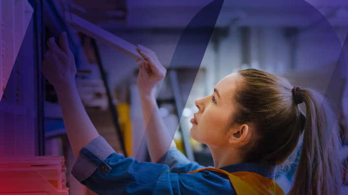 young female worker stocking a warehouse shelf